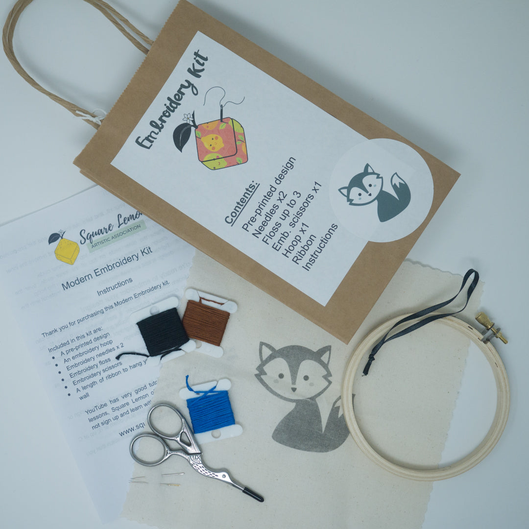 Embroidery kit containing printed image, embroidery floss, needles, scissors and hoop